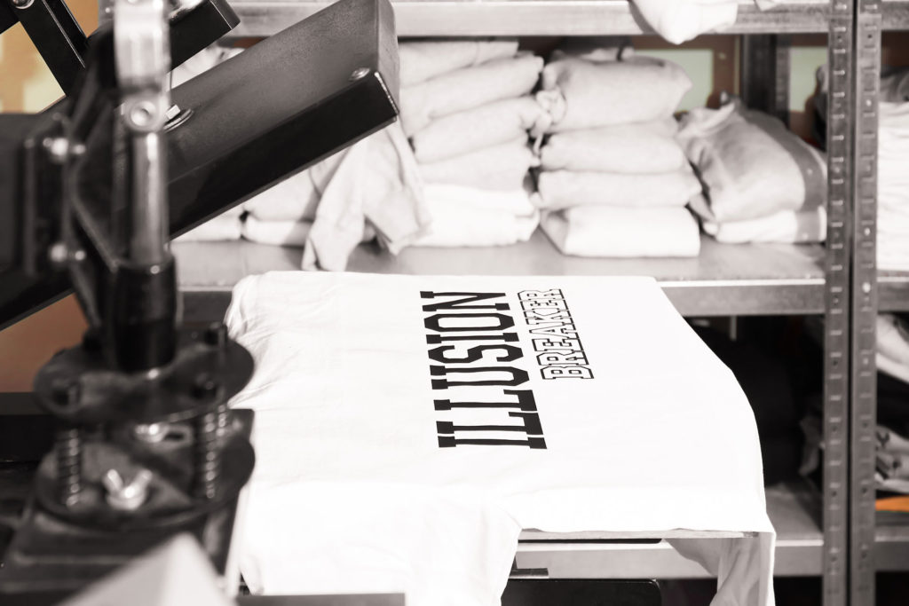 Modern printing machine with t-shirt at workplace textile